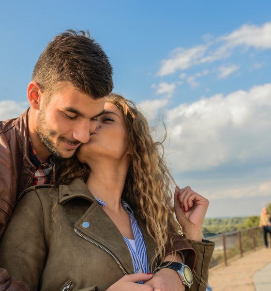 Woman kissing confident man